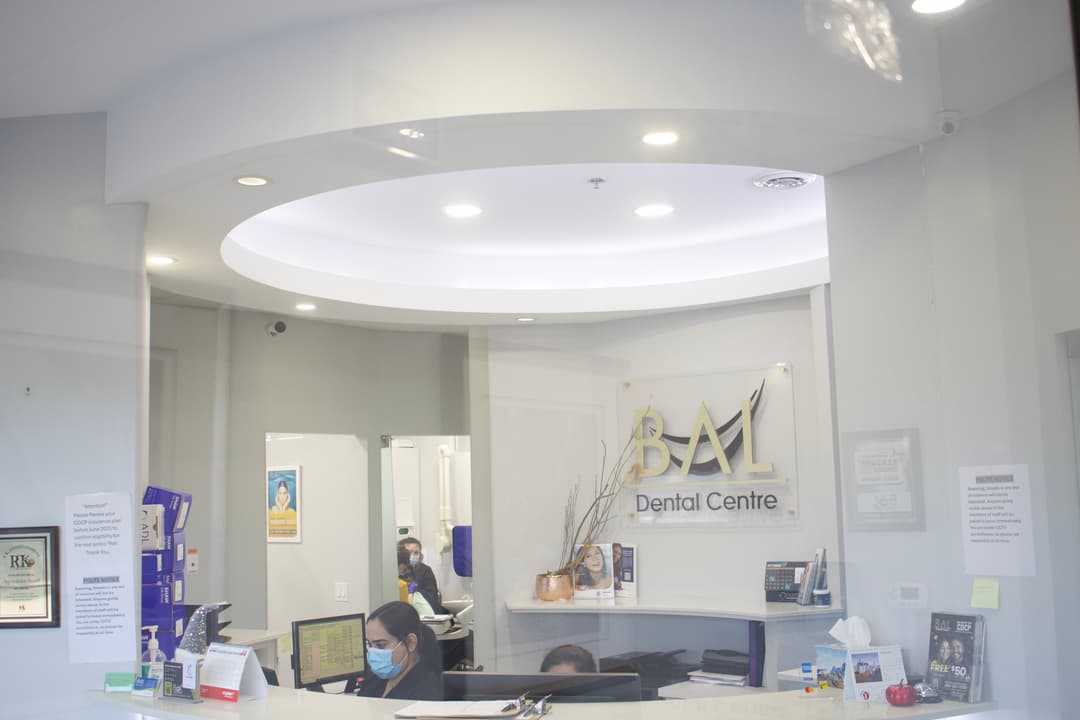 Bal Dental Centre reception with CDCP and insurance information in Scarborough