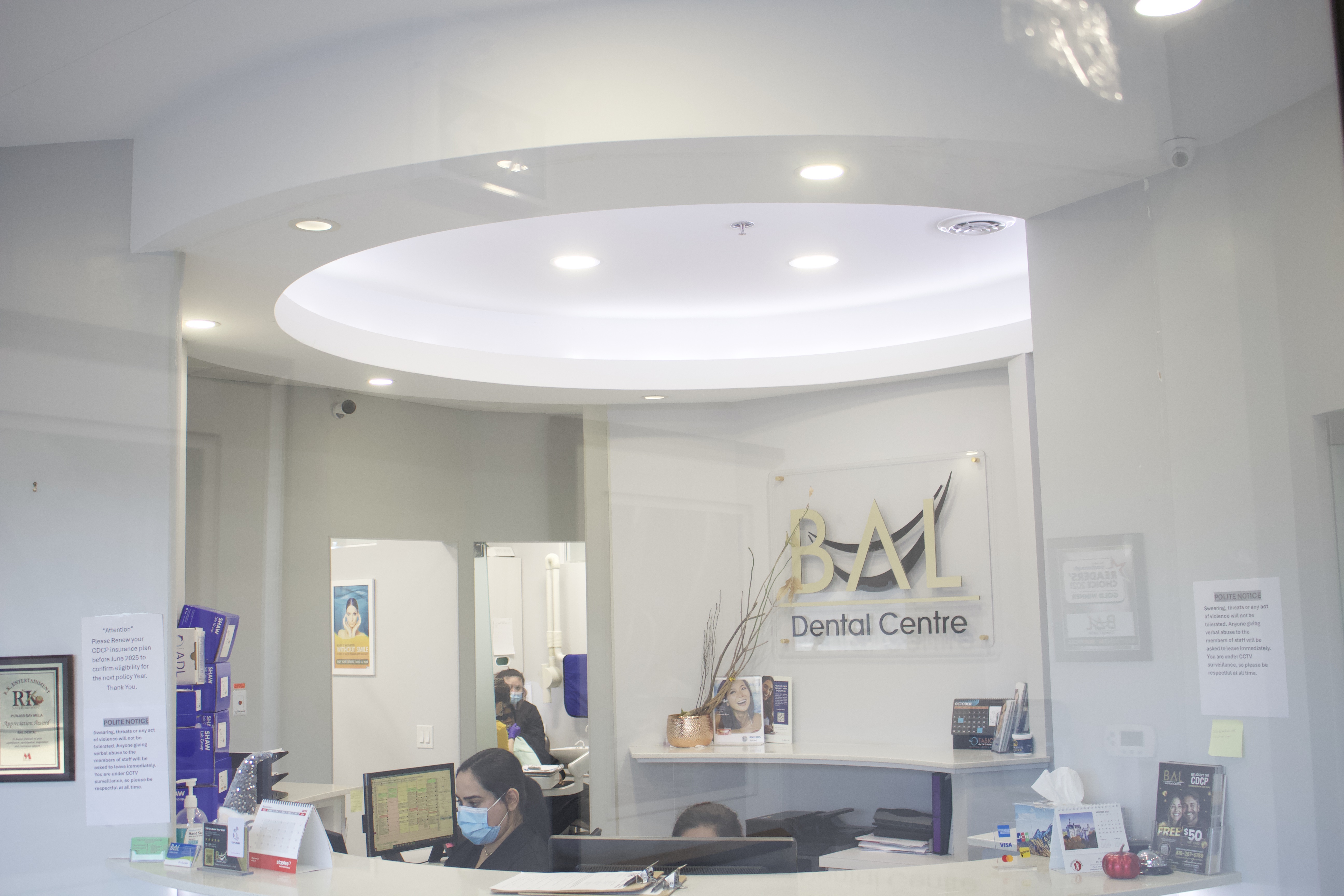 Bal Dental Centre reception with CDCP and insurance information in Scarborough